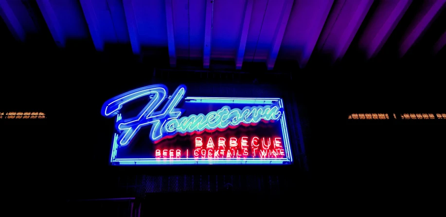 there is a neon sign for a bar and grill