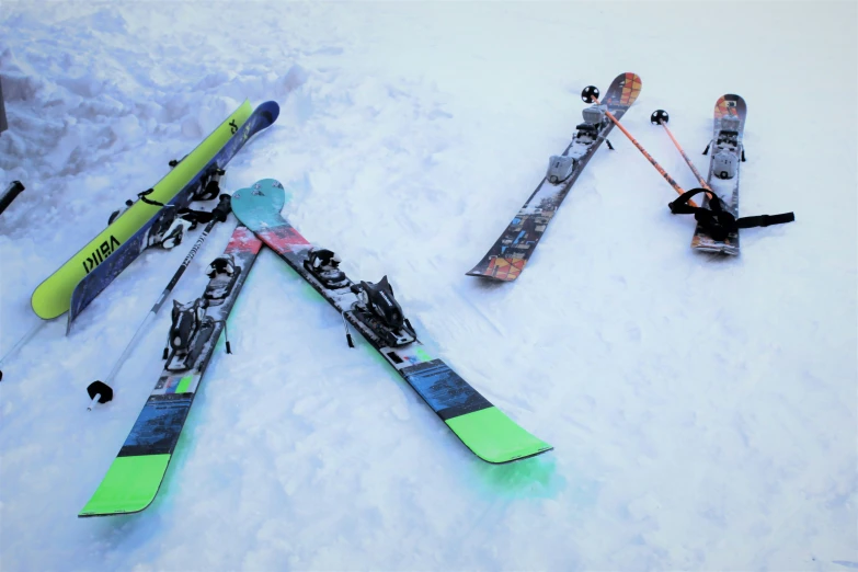 a bunch of different kinds of skis laying on top of the snow