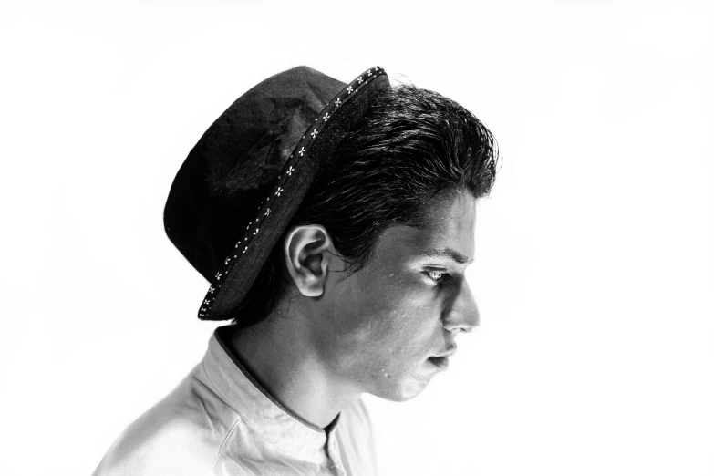 a man with a hat looking at the side