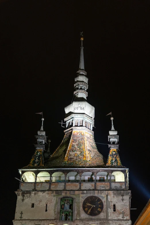 a clock tower that is lit up by the moon