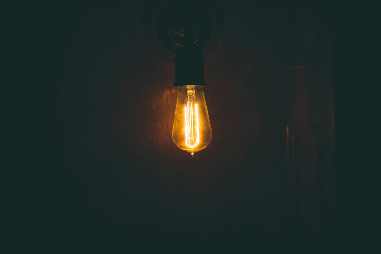 an old fashioned light bulb that is glowing