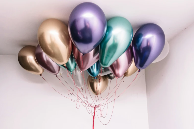 a room with some balloons and string hanging from the ceiling