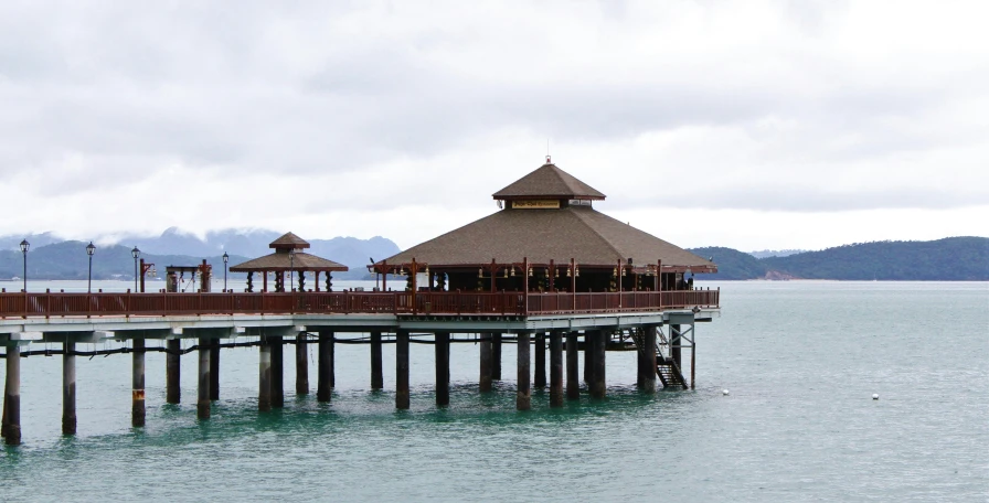 a pier with umbrellas on a lake