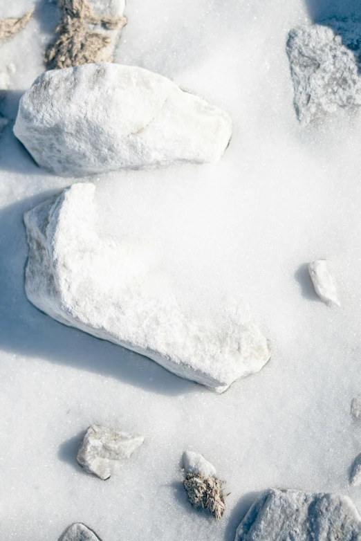 rocks and snow on the ground with light snow