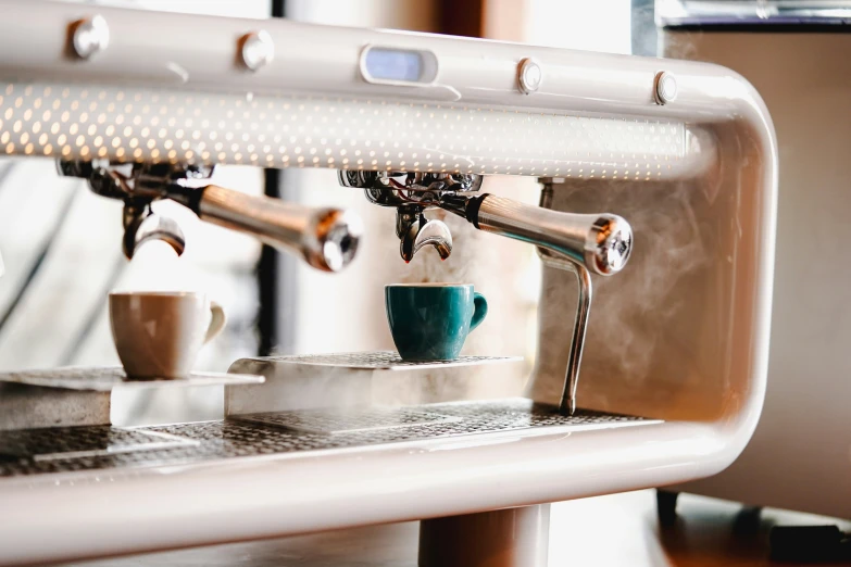 a cup on a machine for making drinks