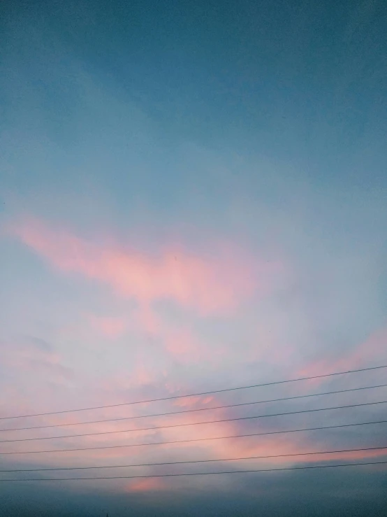 an airplane flying above a group of power lines