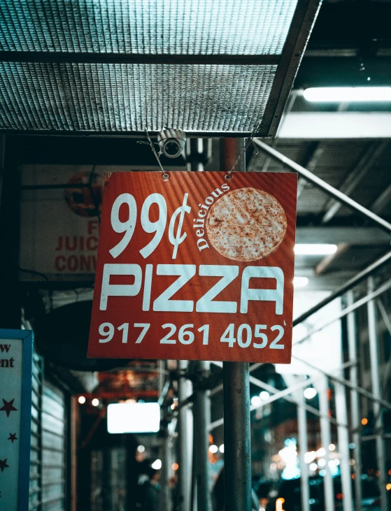 the sign on the pole shows 99 % pizza