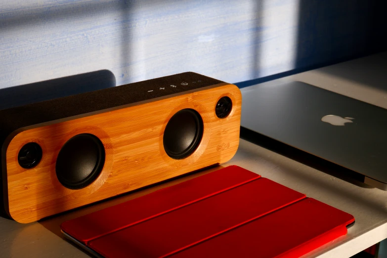 an ipod dock sits next to a wooden speaker