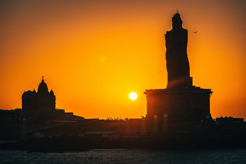 a sun setting over an island in the ocean