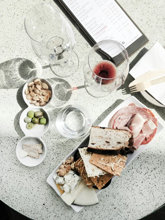 an image of a cheese plate and glass of wine