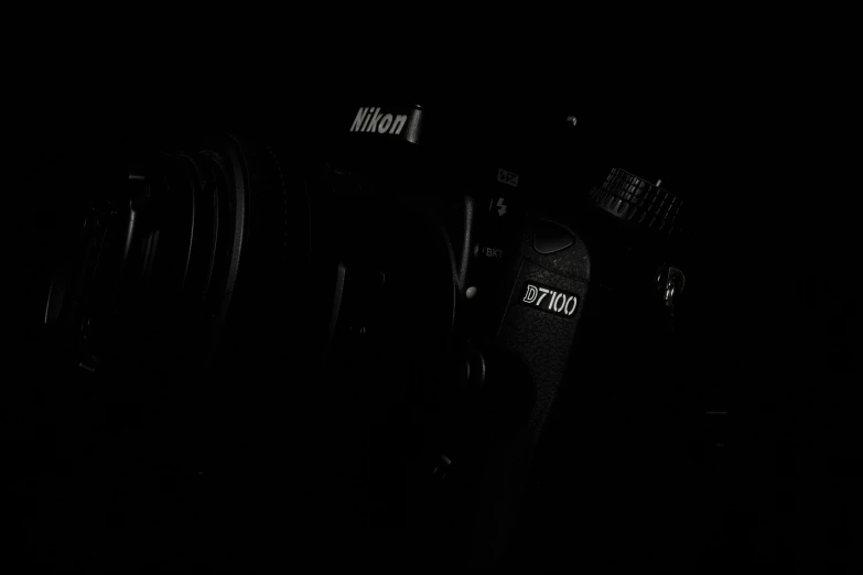 a bunch of cameras and lenses in the dark