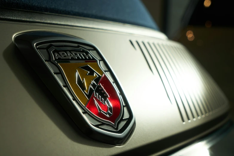 a chrome sports car emblem with the number one on it