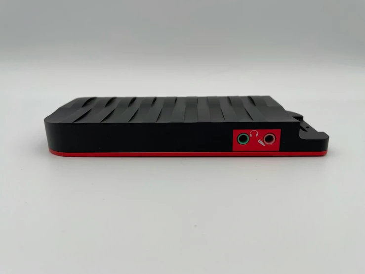 a red and black device on a white surface