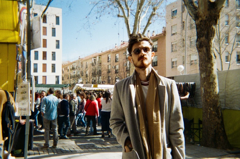 a man standing on the side walk holding a camera