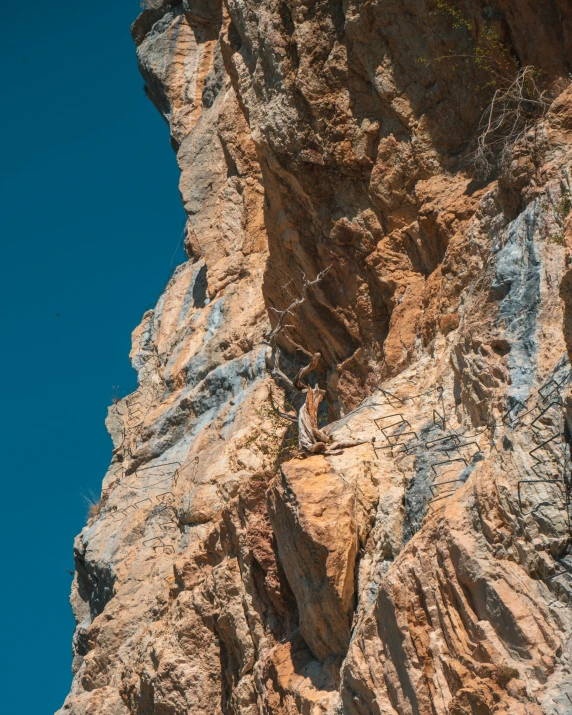 a person climbing up the side of a mountain