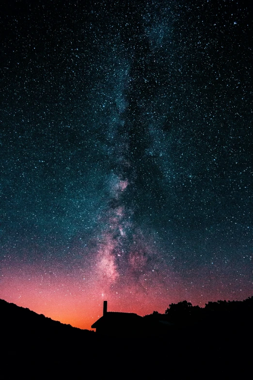 a night sky with some stars and a person looking at the sky