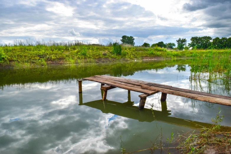 the large wooden beam sits next to the water