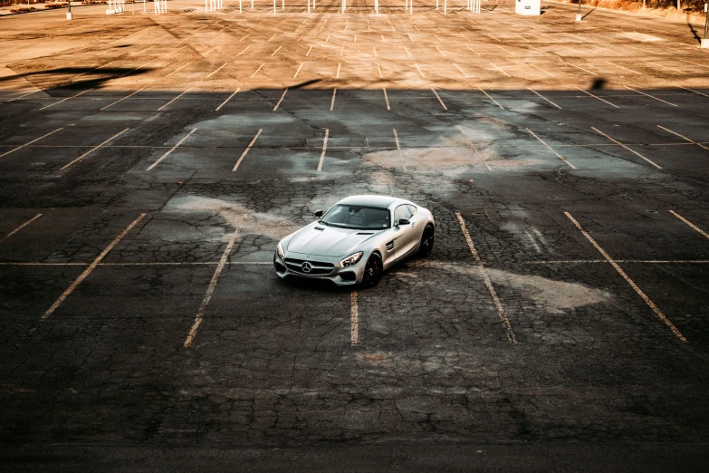 a car in an empty parking lot with lots of chairs and chairs