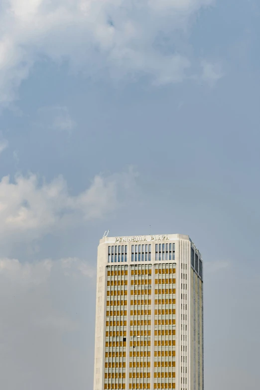 airplane flying in sky over building in urban area