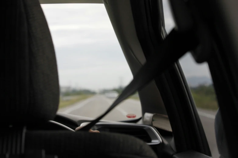 a view from inside the vehicle with cars on the road