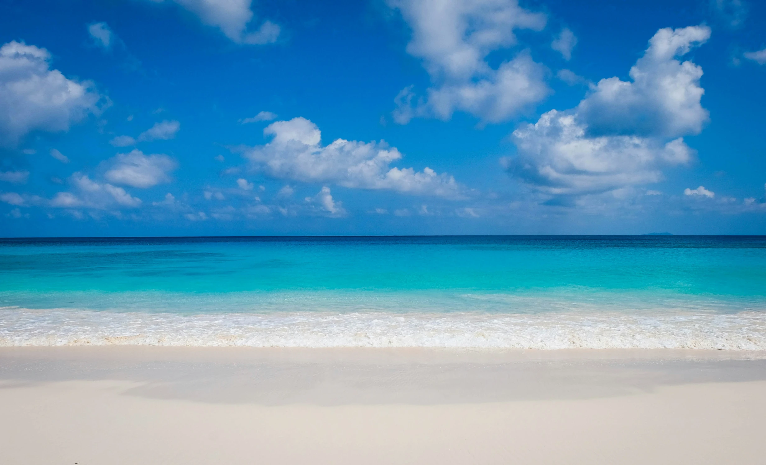 the sand on the ocean is clean and white