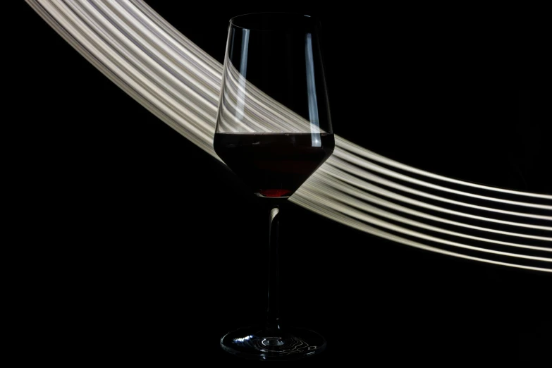 a wine glass is sitting next to some white lines