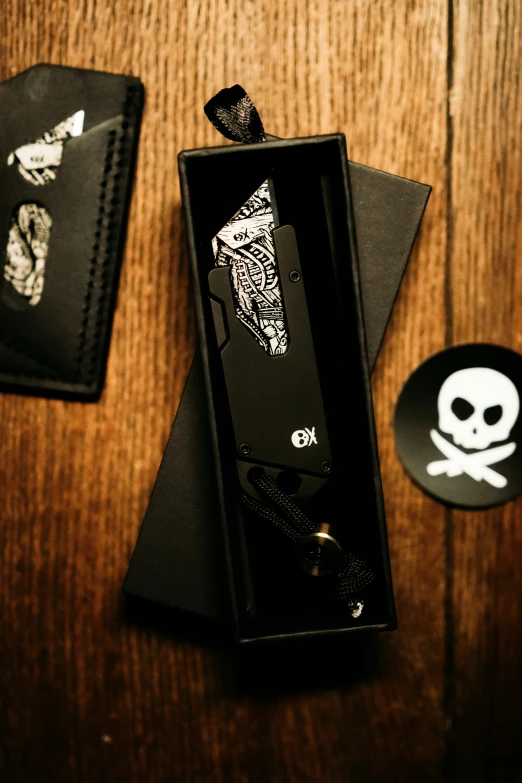 a black watch with skulls, crosses, and bones inside of a box