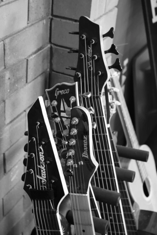 a guitar is sitting against the wall and has its back hanging down