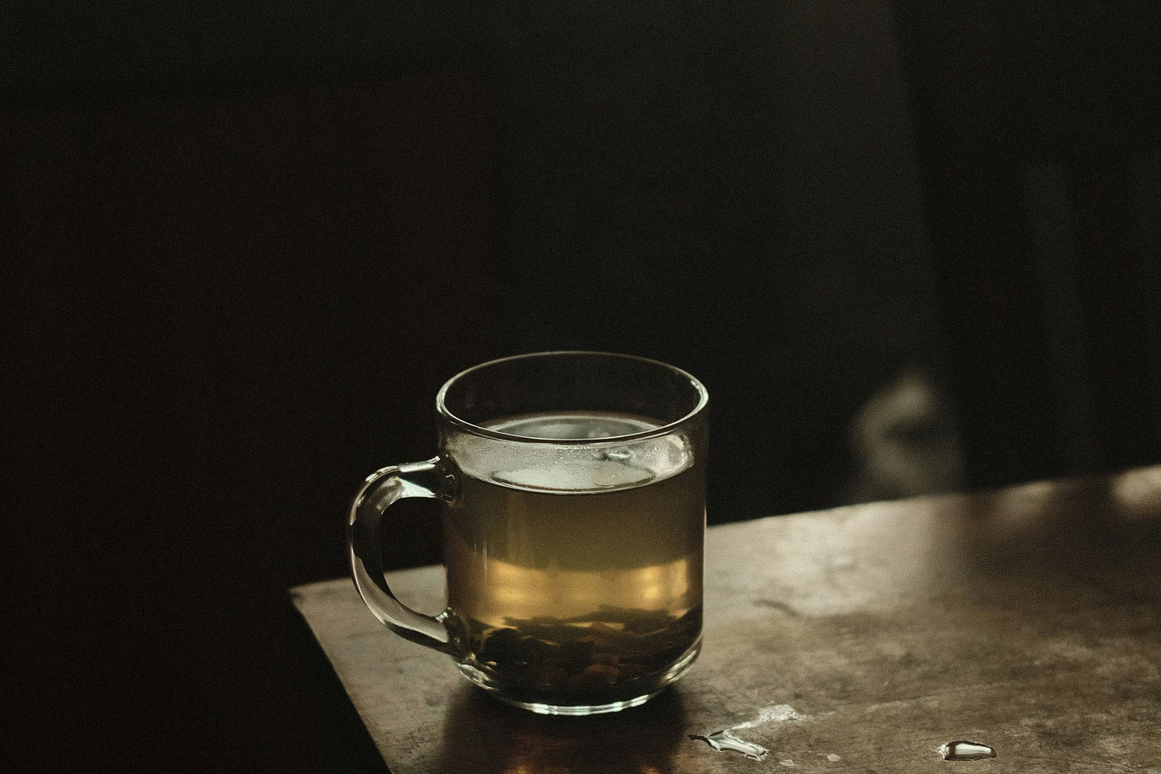 a beer cup sitting on top of a wooden table