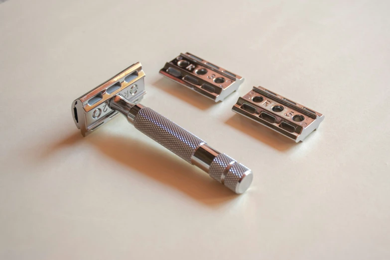 four combs are lined up against a table