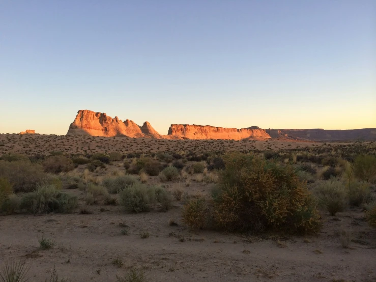 the sunset shines on a barren landscape