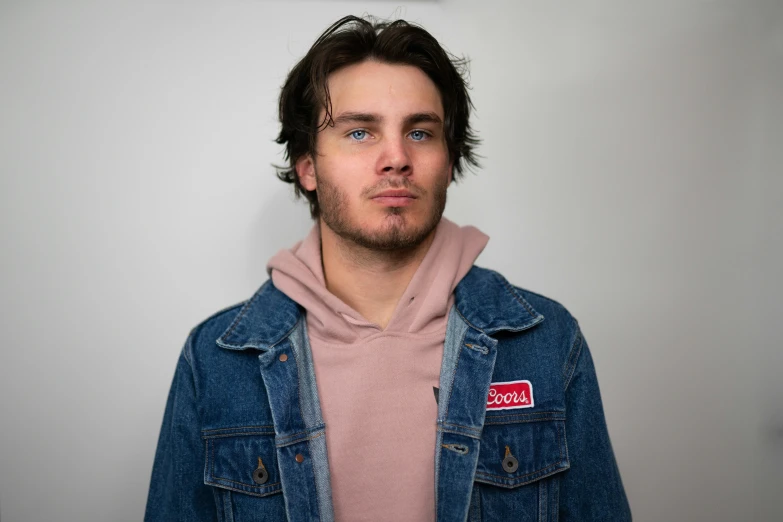 a man with a pink shirt and jean jacket