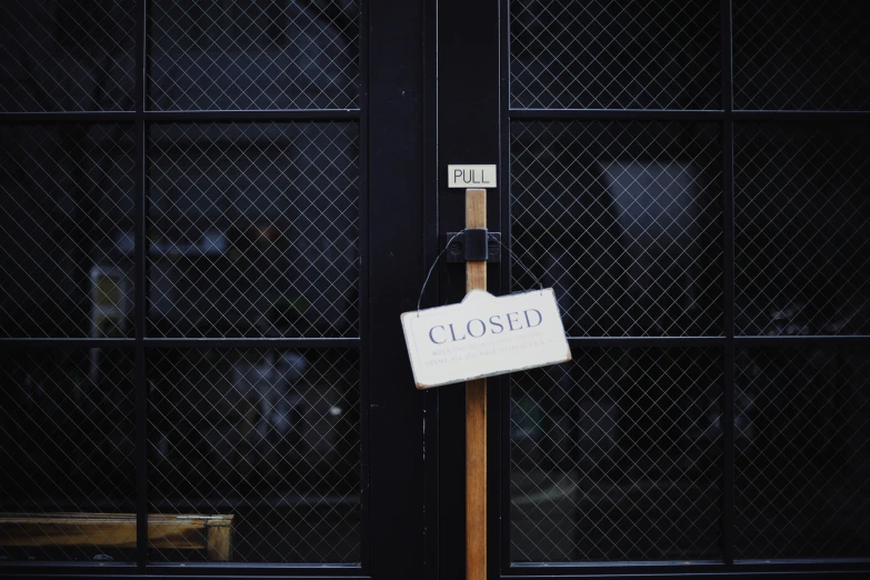 a closed sign is attached to the side of a building