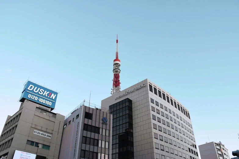 a large grey building that has a sky tower in the background