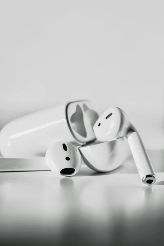 two white earphones sitting next to each other