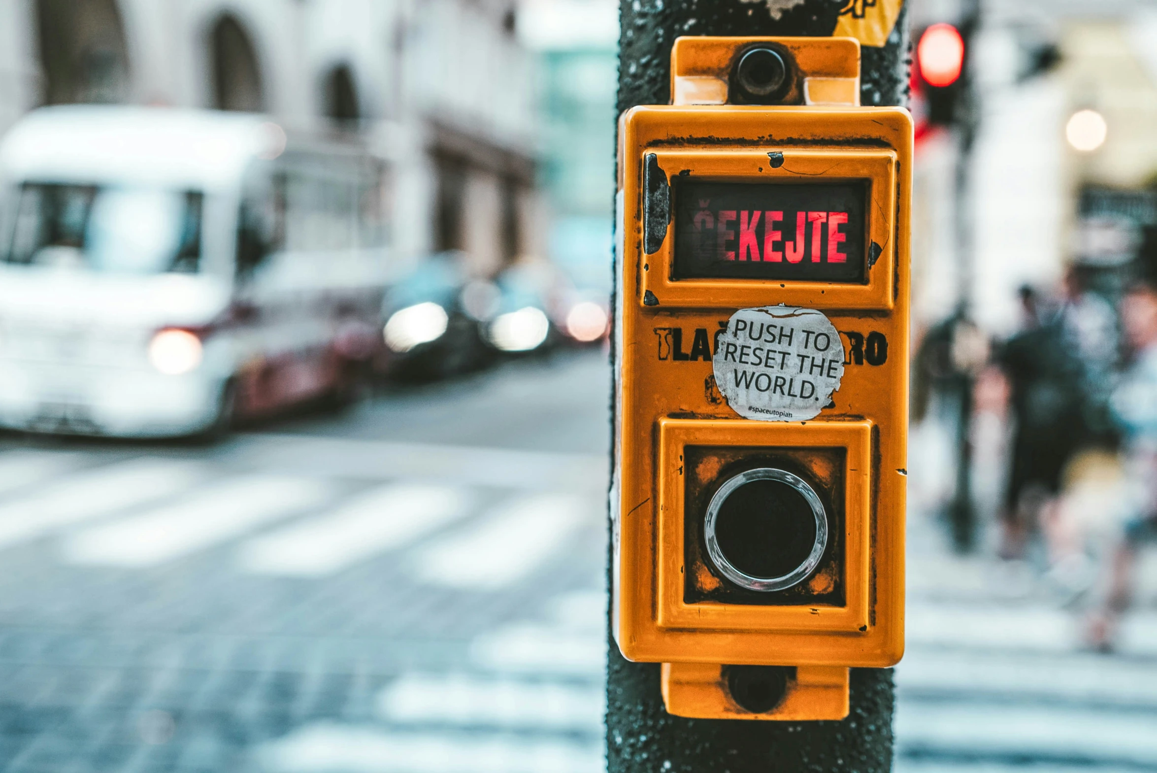 a yellow traffic control box attached to a pole