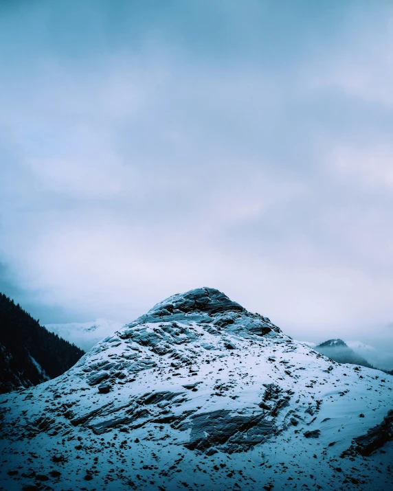 there is snow on the mountain on a cloudy day