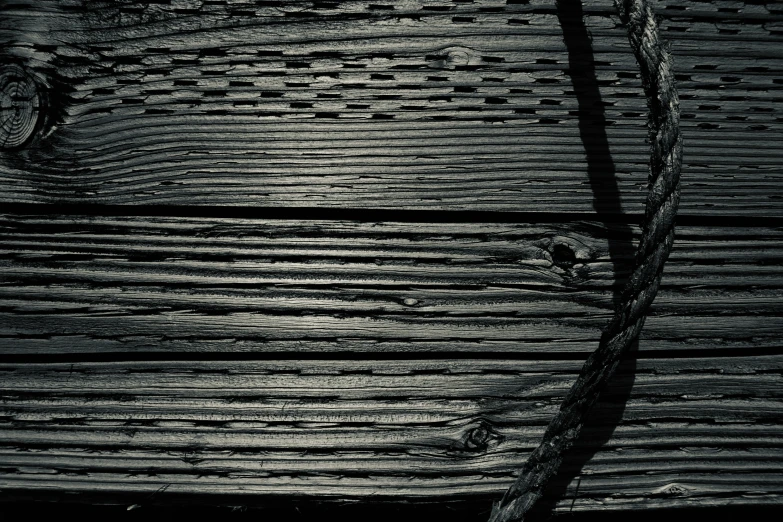 black and white image of wooden board showing scratches