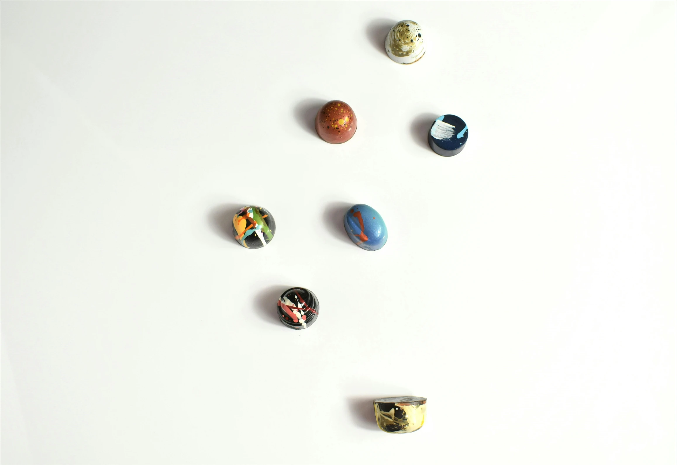 a close up of a collection of different size and shape marbles