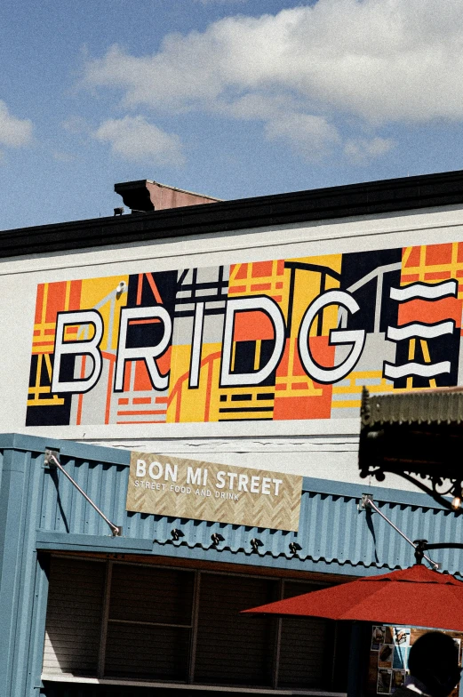 the large building with orange and yellow signs is painted