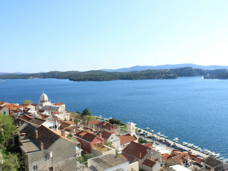 a view of an old village, the bay, and mountains