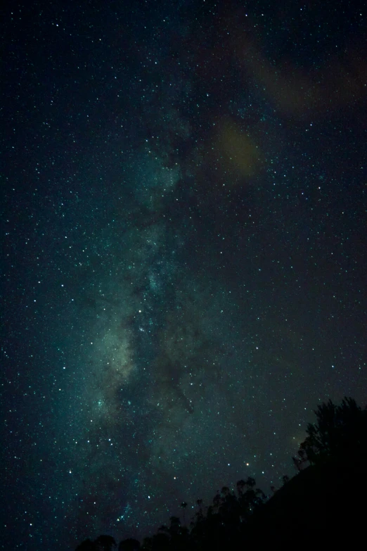 a couple of green and blue lights on the night sky