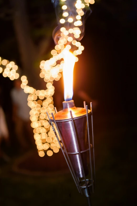 a lit candle with small sparks sticking out of it