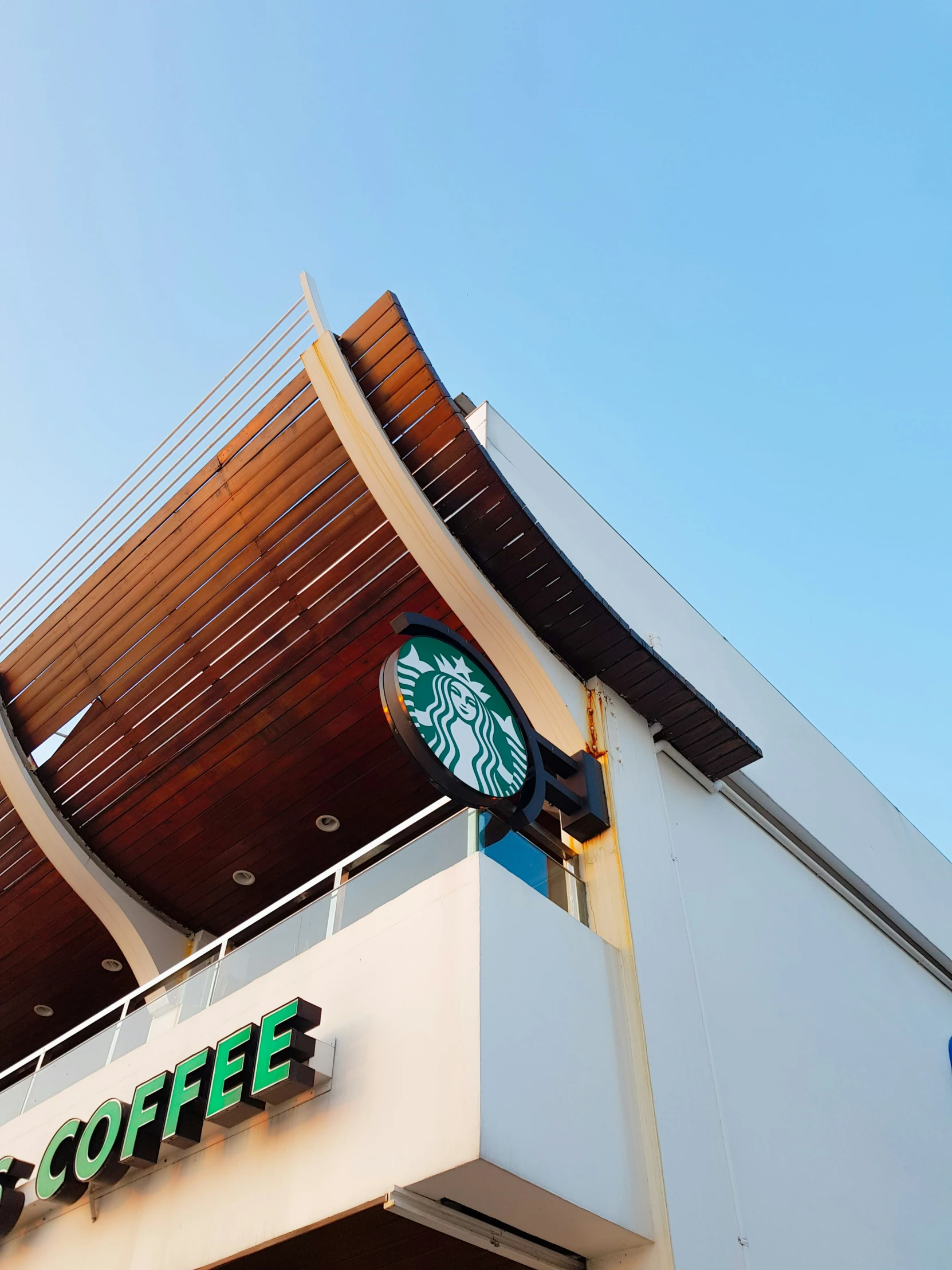 starbucks coffee sign on top of a building