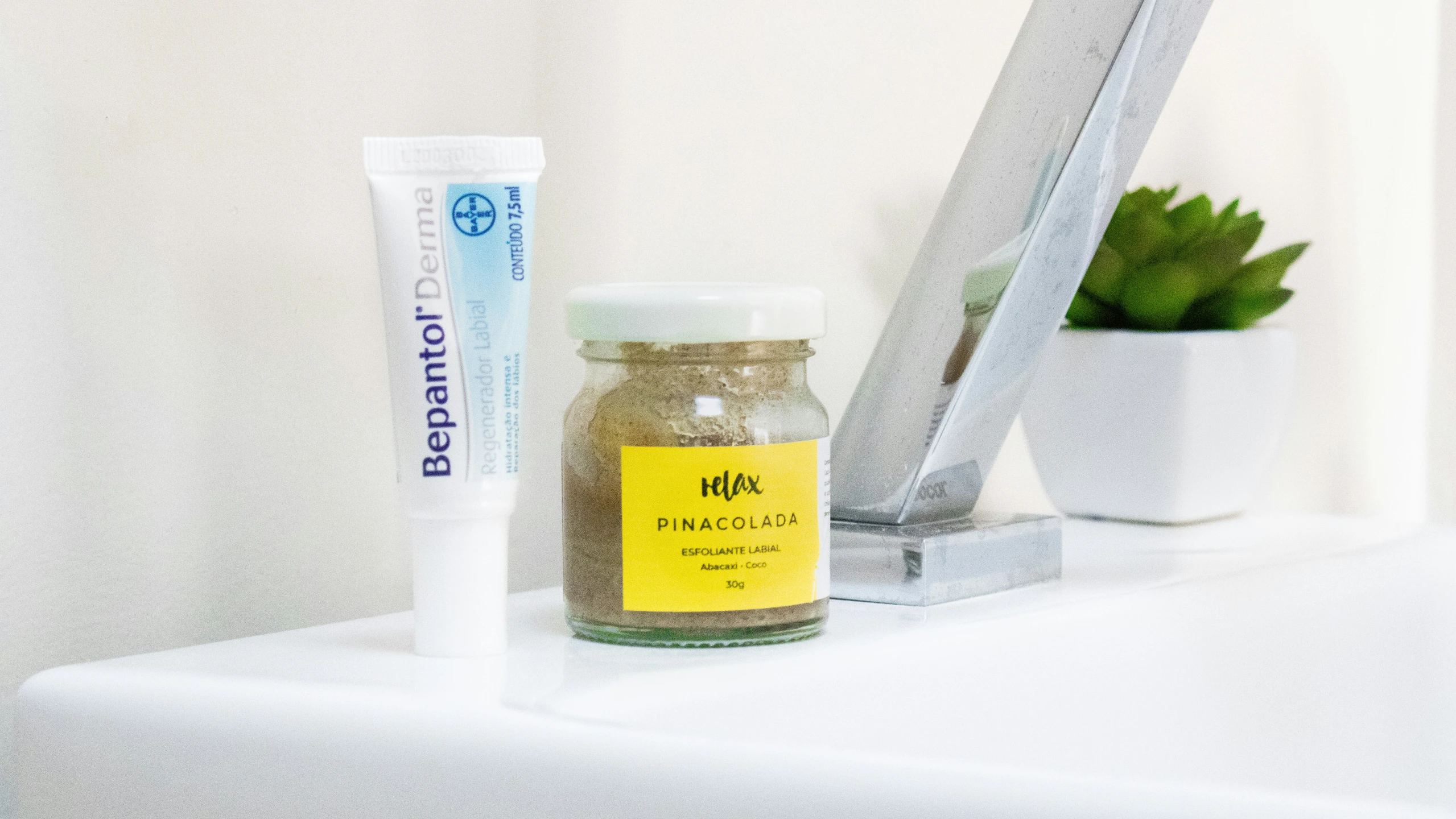 an opened jar of sunflower seed and a tube of sunscreen sitting on a shelf