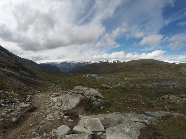 a mountain landscape with large rocks and grass