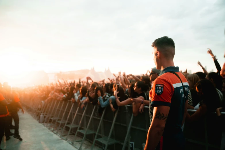 a man standing in front of an audience next to a stage