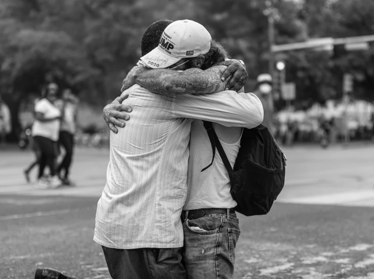 two people emce as they stand on the grass