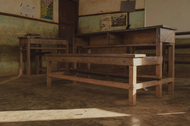 empty benches are lined up next to a window