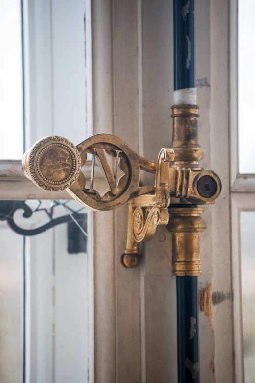 a decorative gold and black lamp on a post